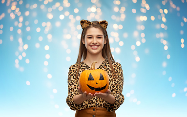 Image showing woman in halloween costume of leopard with pumpkin