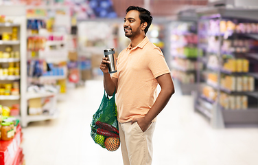 Image showing man with food in bag and tumbler or thermo cup