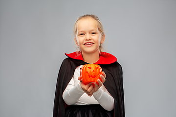 Image showing girl in halloween costume of dracula with pumpkin