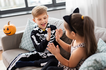 Image showing kids in halloween costumes playing game at home