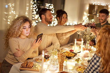 Image showing woman with smartphone at dinner party with friends