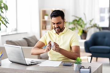 Image showing angry man with laptop working at home office