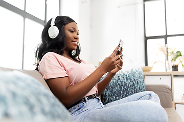 Image showing woman with smartphone listening to music at home