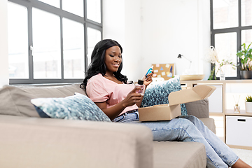 Image showing african american woman with cosmetics at home