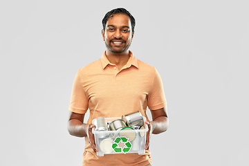 Image showing smiling young indian man sorting metallic waste