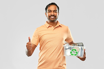 Image showing smiling young indian man sorting metallic waste