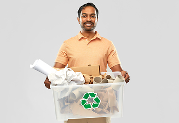 Image showing smiling young indian man sorting paper waste