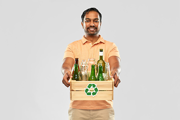 Image showing smiling young indian man sorting glass waste