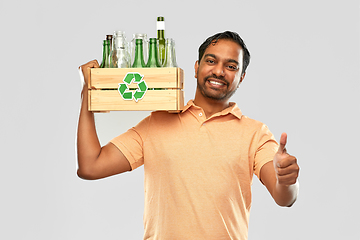 Image showing smiling young indian man sorting glass waste