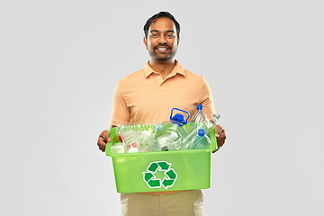 Image showing smiling young indian man sorting plastic waste