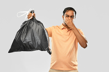 Image showing indian man holding stinky trash bag