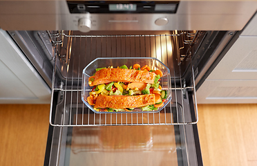 Image showing food cooking in baking dish in oven at home