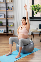 Image showing pregnant woman exercising on fitness ball at home
