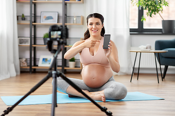 Image showing happy pregnant woman blogger recording yoga video