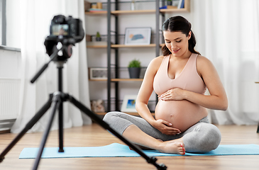 Image showing happy pregnant woman blogger recording yoga video