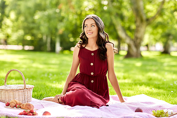 Image showing happy woman with picnic basket at summer park