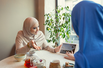 Image showing Beautiful arab women meeting at cafe or restaurant, friends or business meeting