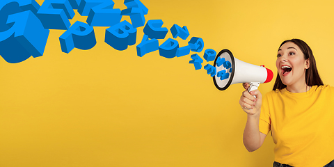 Image showing Woman shouting with megaphone, loudspeaker on studio background. Sales, offer, business, cheering fun concept.