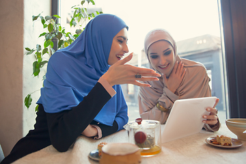 Image showing Beautiful arab women meeting at cafe or restaurant, friends or business meeting