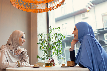 Image showing Beautiful arab women meeting at cafe or restaurant, friends or business meeting