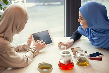 Image showing Beautiful arab women meeting at cafe or restaurant, friends or business meeting