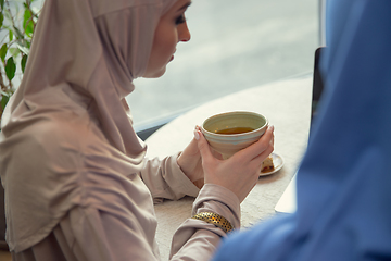 Image showing Beautiful arab women meeting at cafe or restaurant, friends or business meeting