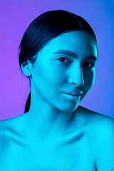 Image showing Beautiful east woman portrait isolated on gradient studio background in neon light, monochrome