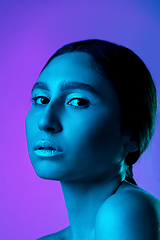 Image showing Beautiful east woman portrait isolated on gradient studio background in neon light, monochrome