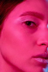 Image showing Beautiful east woman portrait isolated on pink studio background in neon light, monochrome