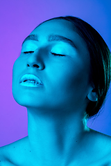 Image showing Beautiful east woman portrait isolated on gradient studio background in neon light, monochrome