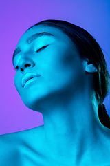 Image showing Beautiful east woman portrait isolated on gradient studio background in neon light, monochrome