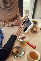 Image showing Beautiful arab women meeting at cafe or restaurant, friends or business meeting