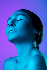 Image showing Beautiful east woman portrait isolated on gradient studio background in neon light, monochrome