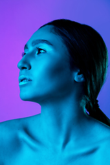 Image showing Beautiful east woman portrait isolated on gradient studio background in neon light, monochrome