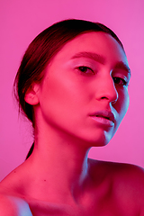 Image showing Beautiful east woman portrait isolated on pink studio background in neon light, monochrome