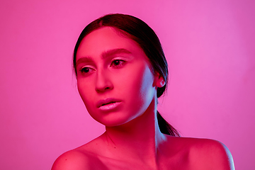 Image showing Beautiful east woman portrait isolated on pink studio background in neon light, monochrome