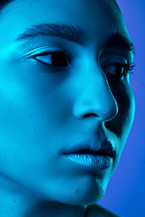 Image showing Beautiful east woman portrait isolated on gradient studio background in neon light, monochrome