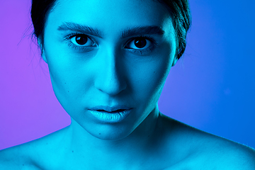 Image showing Beautiful east woman portrait isolated on gradient studio background in neon light, monochrome