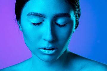 Image showing Beautiful east woman portrait isolated on gradient studio background in neon light, monochrome