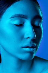 Image showing Beautiful east woman portrait isolated on gradient studio background in neon light, monochrome