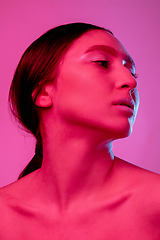 Image showing Beautiful east woman portrait isolated on pink studio background in neon light, monochrome