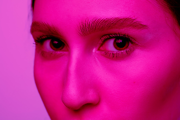 Image showing Beautiful east woman portrait isolated on pink studio background in neon light, monochrome