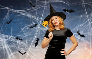 Image showing woman in halloween costume of witch with pumpkin