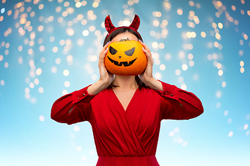 Image showing woman in halloween costume of devil with pumpkin