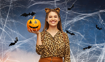 Image showing woman in halloween costume of leopard with pumpkin