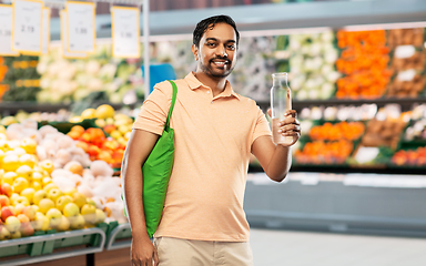 Image showing man with bag for food shopping and glass bottle