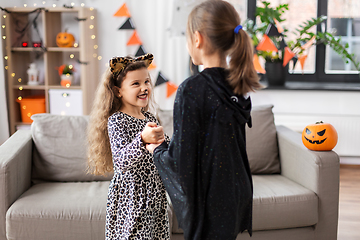 Image showing girls in halloween costumes dancing at home