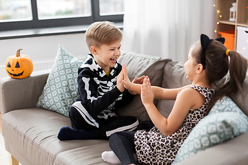 Image showing kids in halloween costumes playing game at home