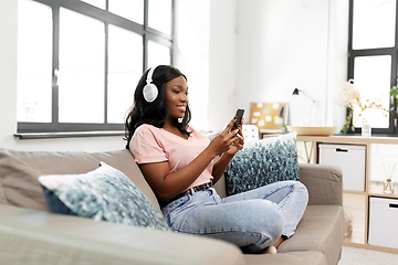 Image showing woman with smartphone listening to music at home