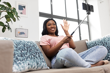 Image showing happy african american woman taking selfie at home